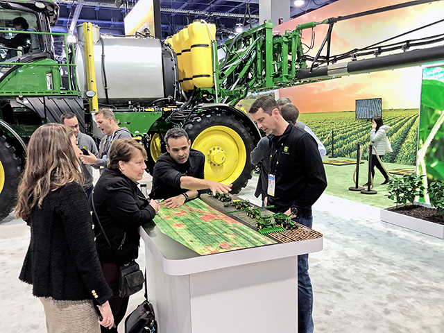 Julian Sanchez, second from right explains Deere&#039;s "See and Spray" at the Consumer Electronics Show. (Progressive Farmer image by Dan Miller)